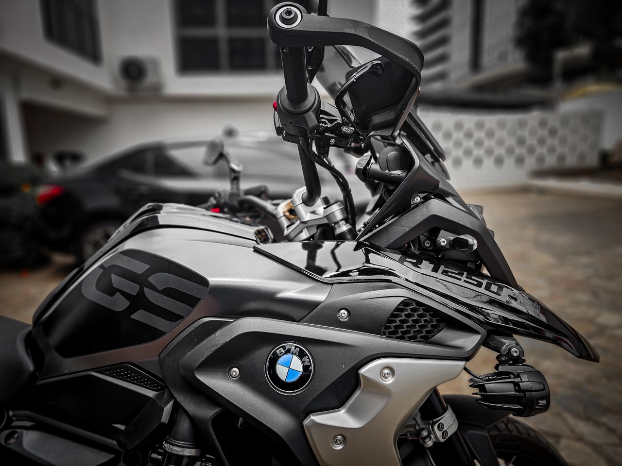 Detailed image of a black BMW motorcycle parked outdoors in Accra, Ghana.